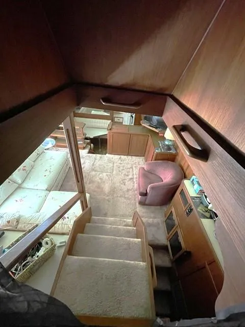Slide: The Image of 1984 Uniflite Double Cabin interior with stairs, seating, and wood paneling. - 10