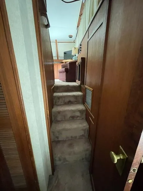 Slide: The Image of 1984 Uniflite Double Cabin interior stairs with wooden paneling. - 15