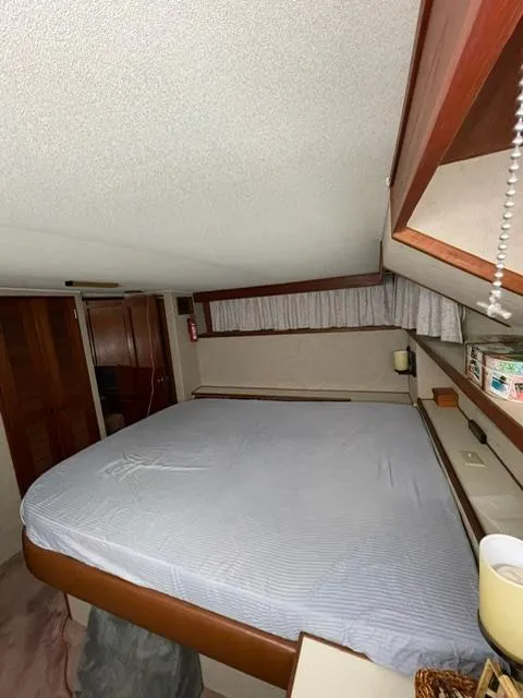 Slide: The Image of 1984 Uniflite Double Cabin bedroom with bed, wooden accents, and storage. - 18