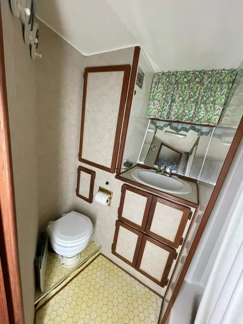 Slide: The Image of 1984 Uniflite Double Cabin bathroom with sink, toilet, and storage cabinets. - 20