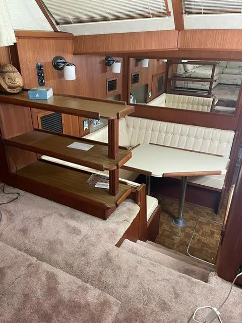 Slide: The Image of 1984 Uniflite Double Cabin interior with wooden stairs and dining area. - 23