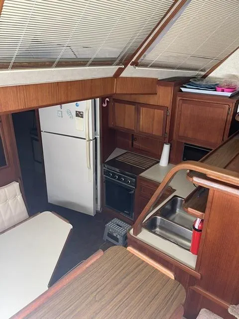 Slide: The Image of 1984 Uniflite Double Cabin kitchen area with wooden cabinetry and appliances. - 24