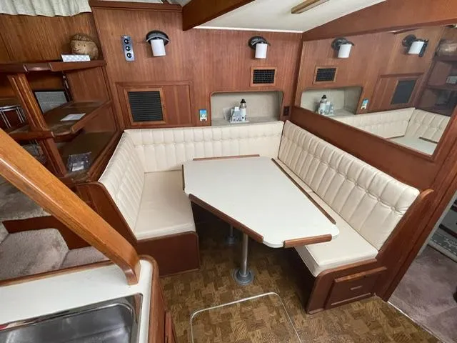 Slide: The Image of 1984 Uniflite Double Cabin interior with dining area and wood paneling. - 25