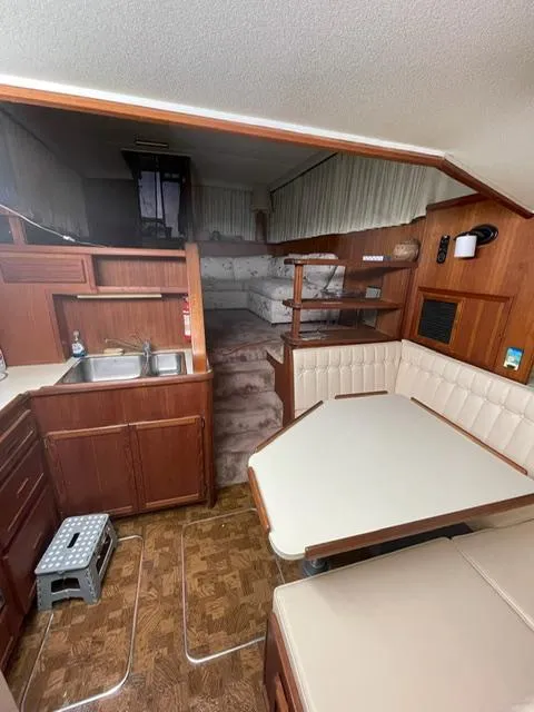 Slide: The Image of 1984 Uniflite Double Cabin interior with kitchen, dining area, and sleeping quarters. - 26
