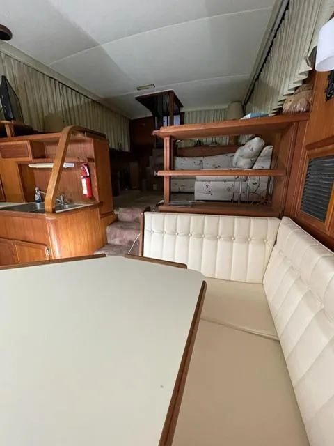 Slide: The Image of 1984 Uniflite Double Cabin interior with dining area and lounge. - 28