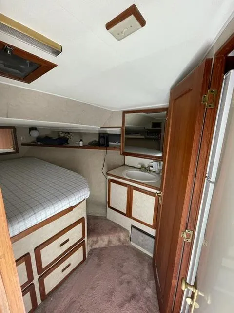 Slide: The Image of 1984 Uniflite Double Cabin interior with bed, storage drawers, and sink. - 29