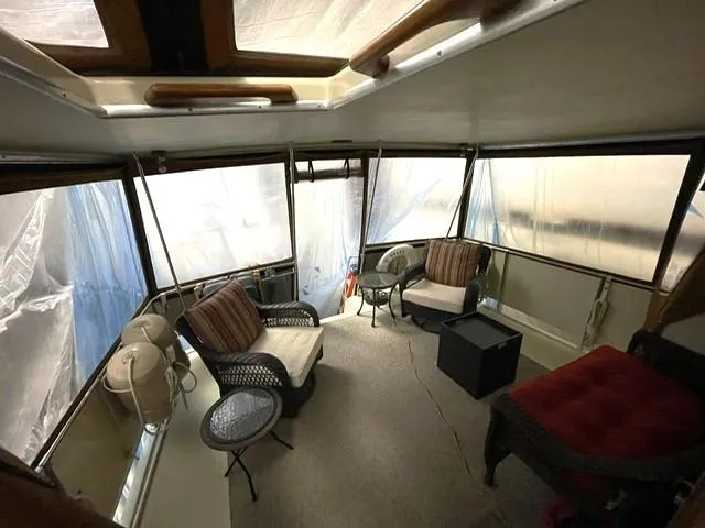 Slide: The Image of 1984 Uniflite Double Cabin interior with seating and large windows. - 3