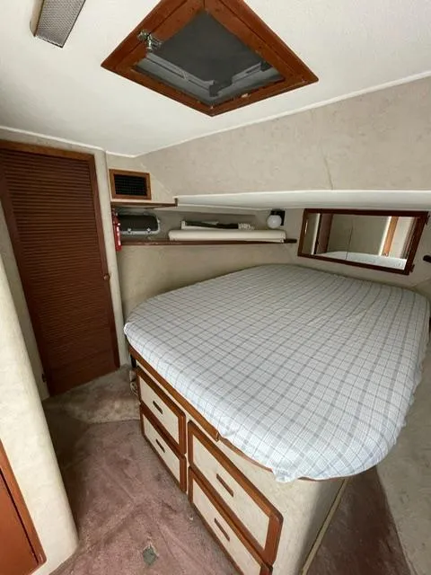 Slide: The Image of 1984 Uniflite Double Cabin interior with bed, storage, and wooden accents. - 30