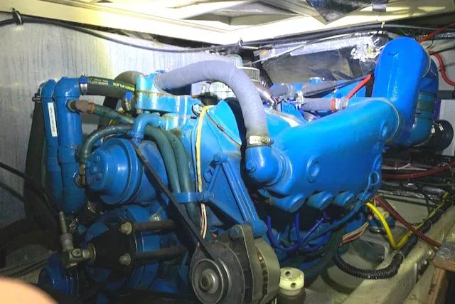 Slide: The Image of 1984 Uniflite Double Cabin engine compartment with blue marine engine. - 34