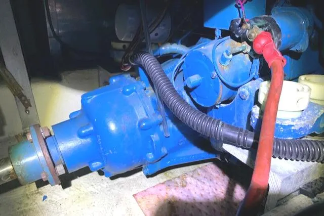 Slide: The Image of Engine compartment of a 1984 Uniflite Double Cabin boat with blue mechanical components. - 36