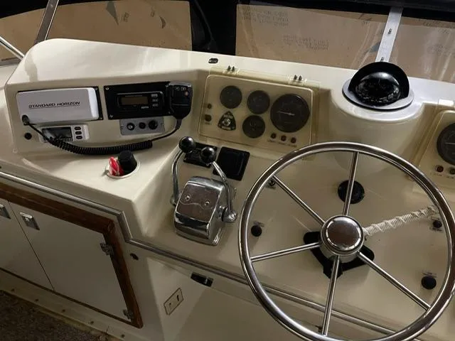 Slide: The Image of 1984 Uniflite Double Cabin helm with steering wheel, controls, and navigation instruments. - 6