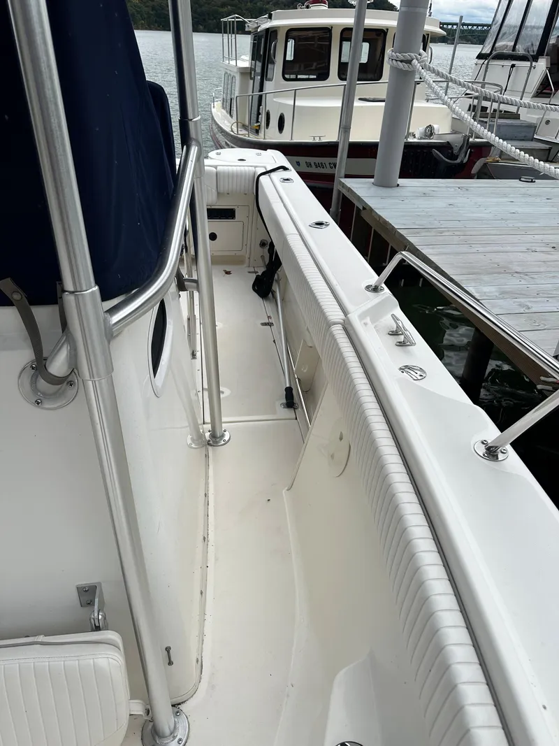 Slide: The Image of 2000 Boston Whaler 23 Outrage boat docked, side view. - 14