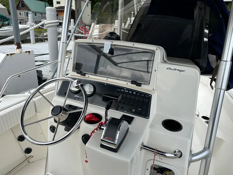 Slide: The Image of Boston Whaler 23 Outrage 2000 model boat console with steering wheel and controls. - 20