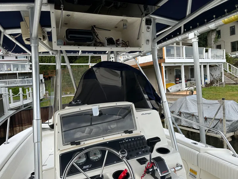 Slide: The Image of 2000 Boston Whaler 23 Outrage boat cockpit with steering wheel and control panel. - 21