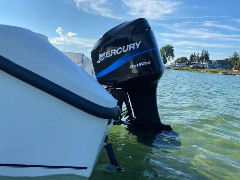 Slide: The Image of Boston Whaler 23 Outrage 2000 with Mercury OptiMax engine in water. - 23