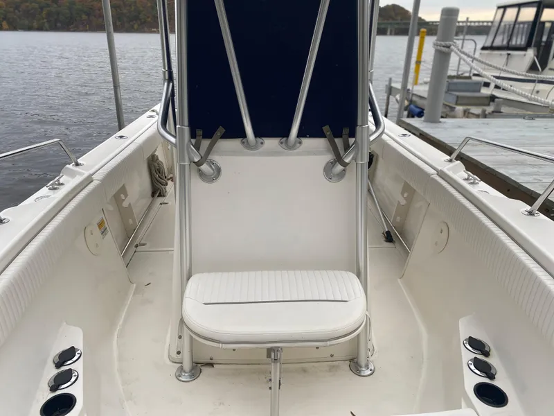 Slide: The Image of Boston Whaler 23 Outrage 2000 model boat interior with seating and rod holders. - 6