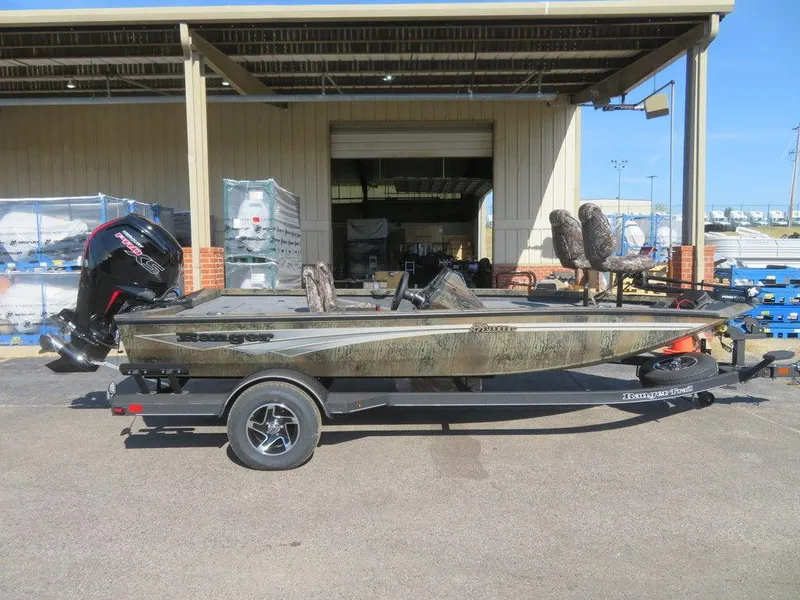 Slide: The Image of 2024 Ranger RT188P fishing boat on trailer outside a warehouse. - 1