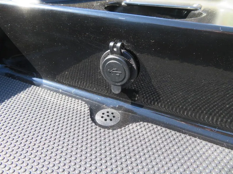 Slide: The Image of 2024 Ranger RT188P boat USB port and drainage hole on textured surface. - 18