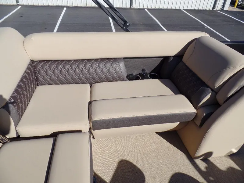 Slide: The Image of 2024 Harris Sunliner 230 boat interior with beige and gray cushioned seating. - 10
