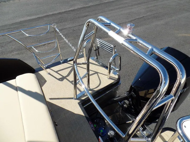 Slide: The Image of 2024 Harris Sunliner 230 boat with stainless steel railings and beige seating. - 17