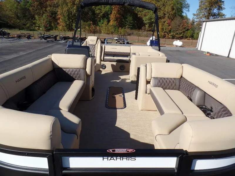 Slide: The Image of 2024 Harris Sunliner 230 pontoon boat with spacious seating and modern design. - 4