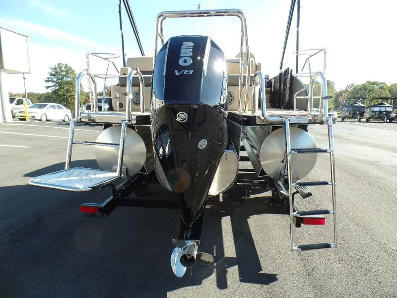 Slide: The Image of 2024 Harris Sunliner 230 pontoon boat with Mercury V8 engine, rear view. - 5