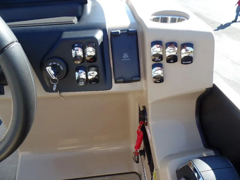 Slide: The Image of Control panel of 2024 Harris Sunliner 230 boat with ignition and switches. - 8
