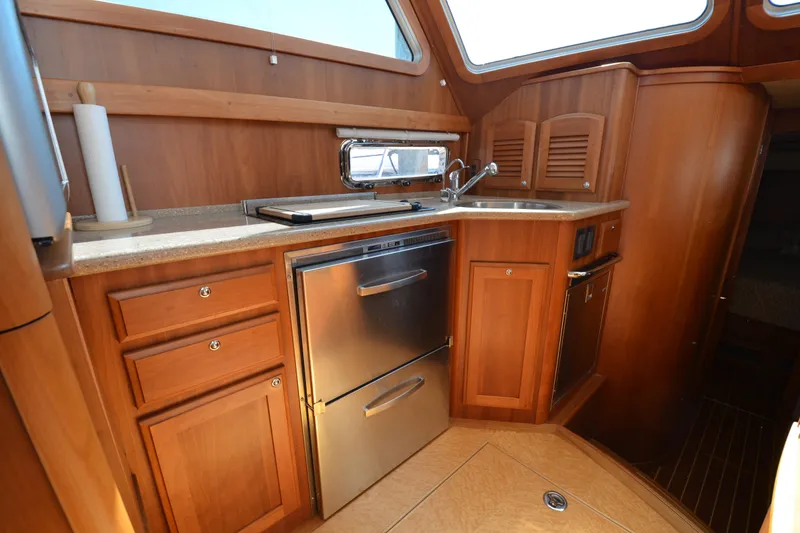 Slide: The Image of Luxurious 2014 Sabre 42 Salon Express yacht kitchen with wood cabinetry and stainless steel appliances. - 21