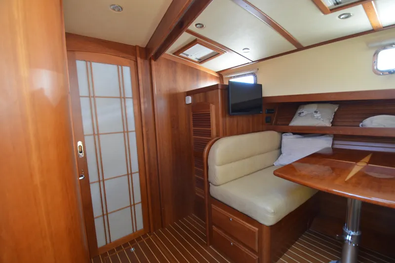 Slide: The Image of 2014 Sabre 42 Salon Express interior with wood finish, seating, and table. - 26