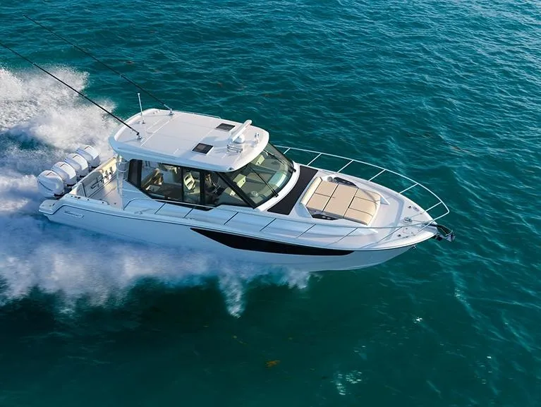 The Image of 2024 Boston Whaler 405 Conquest cruising on clear blue ocean waters. - 0