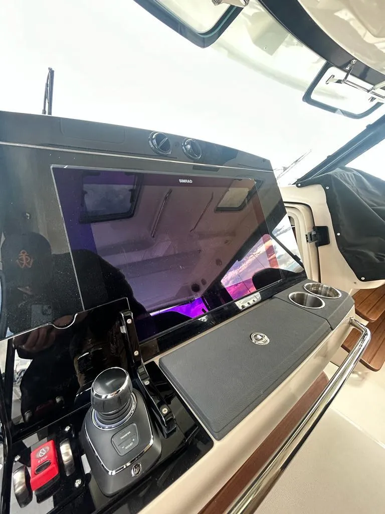 Slide: The Image of 2024 Boston Whaler 405 Conquest helm with advanced navigation controls and display. - 11