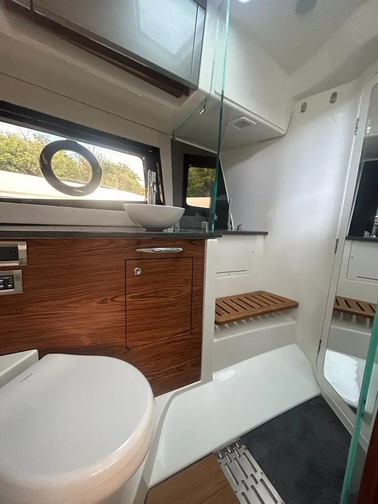 Slide: The Image of 2024 Boston Whaler 405 Conquest bathroom with modern fixtures and wood accents. - 12