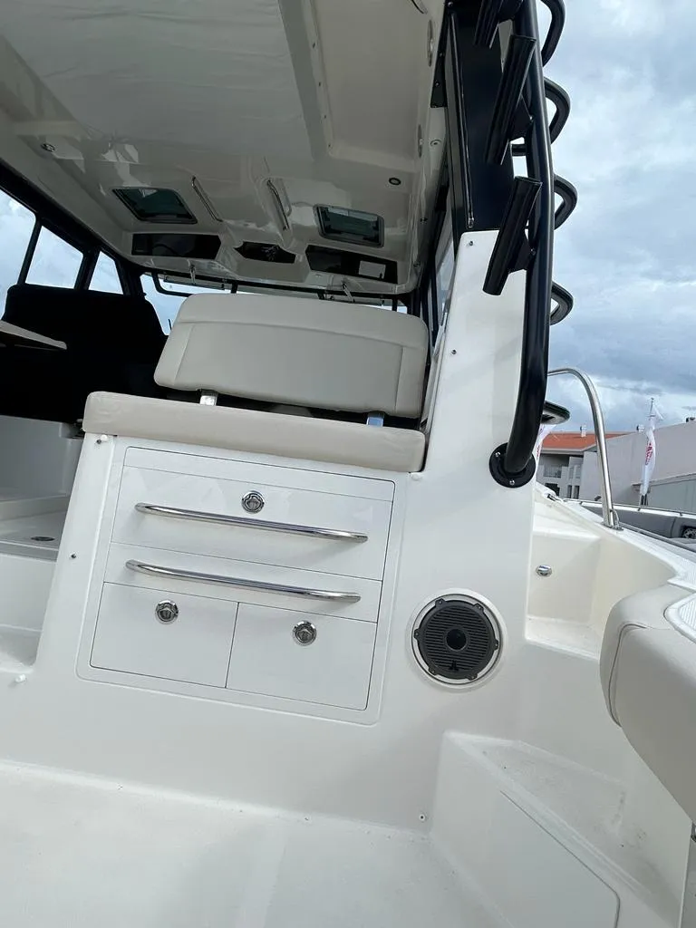 Slide: The Image of 2024 Boston Whaler 405 Conquest interior with seating and storage, showcasing modern design. - 4