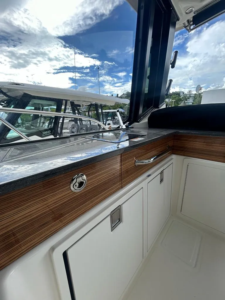 Slide: The Image of 2024 Boston Whaler 405 Conquest interior with sleek wood finish and modern design. - 6