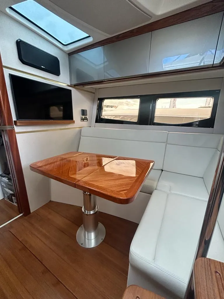 Slide: The Image of 2024 Boston Whaler 405 Conquest interior with sleek dining area and modern finishes. - 9
