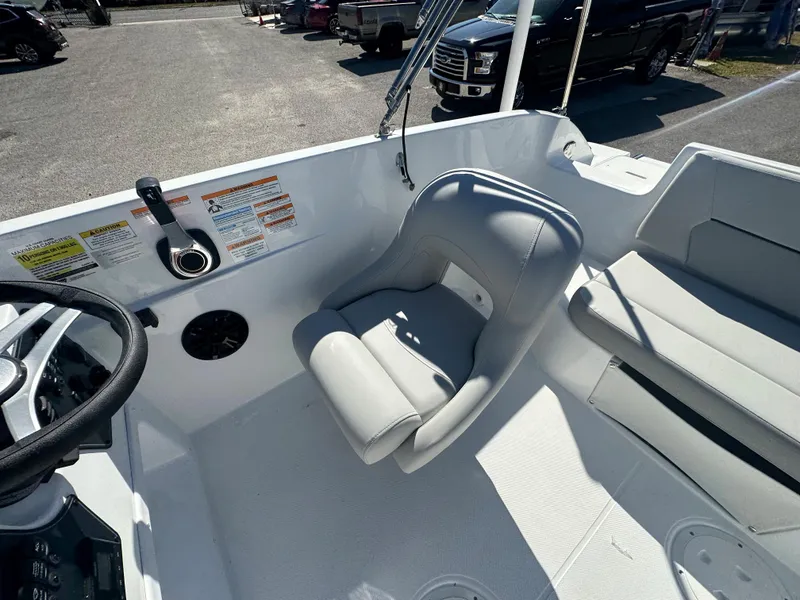Slide: The Image of 2024 Hurricane SunDeck Sport 188 OB boat interior with captain's chair and control panel. - 10