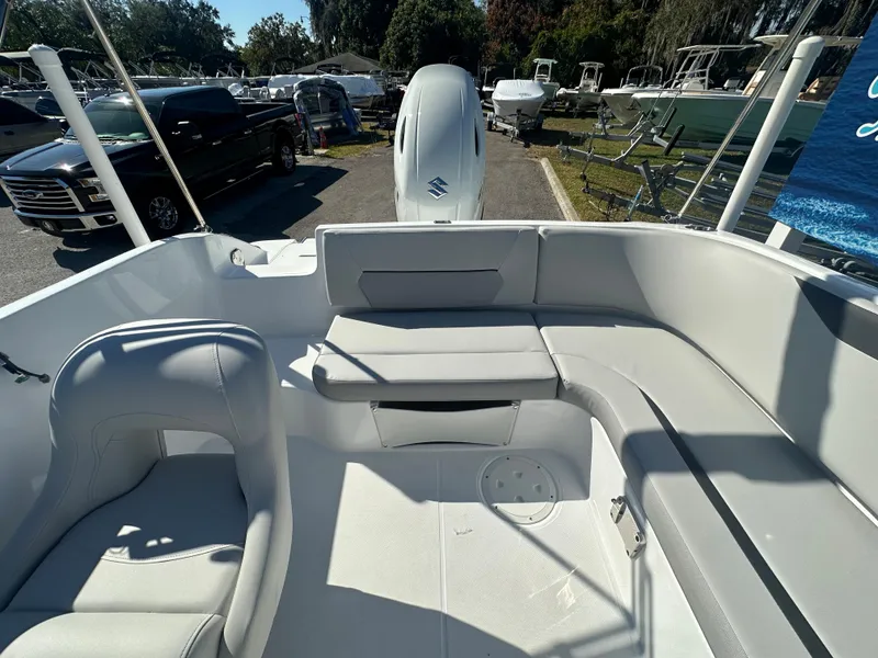 Slide: The Image of 2024 Hurricane SunDeck Sport 188 OB boat interior with seating and outboard motor. - 11