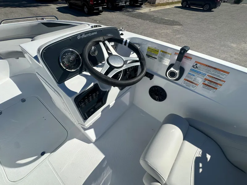 Slide: The Image of 2024 Hurricane SunDeck Sport 188 OB boat cockpit with steering wheel and control panel. - 9