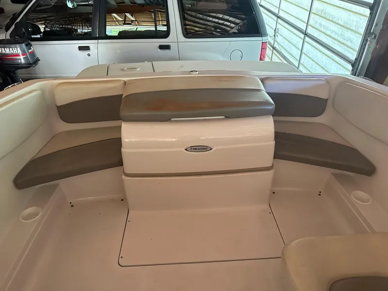 Slide: The Image of 2003 Four Winns 180 Freedom I/O boat interior with seating and storage. - 9