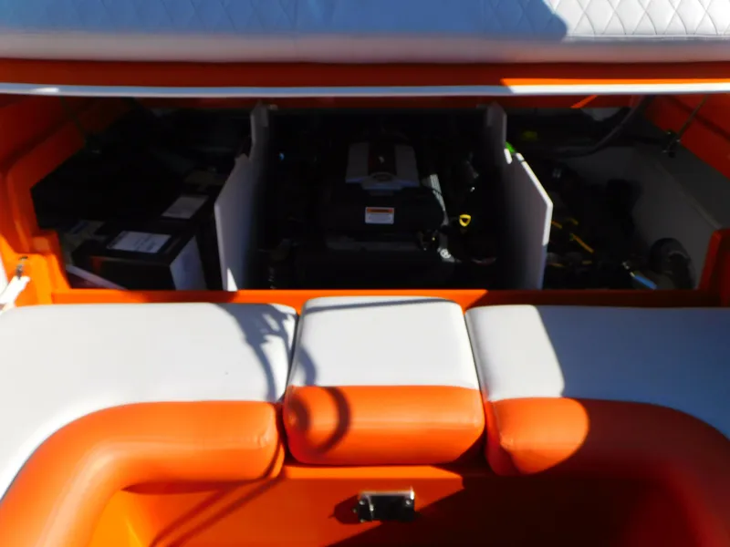 Slide: The Image of 2024 Crownline 240 SS LPX boat engine compartment with orange and white seating. - 13