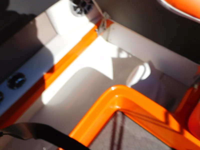 Slide: The Image of Interior of 2024 Crownline 240 SS LPX boat with orange and white accents. - 14