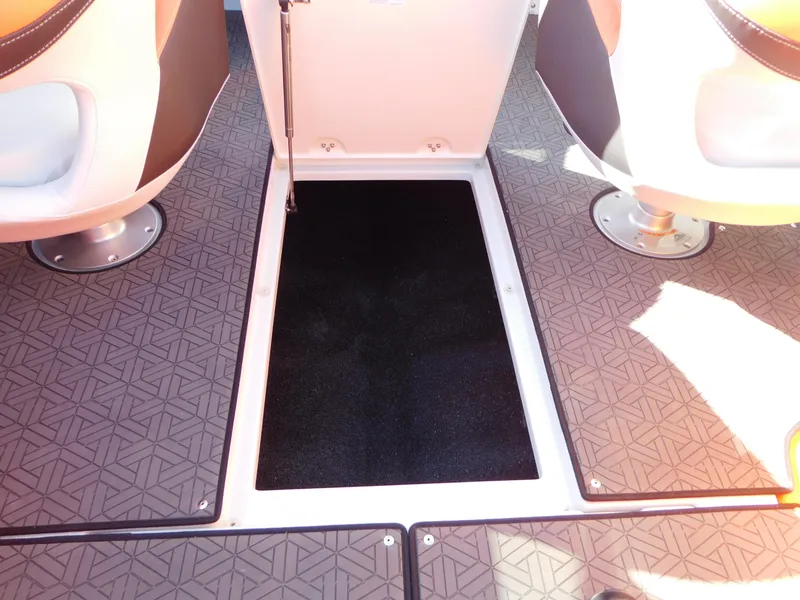 Slide: The Image of 2024 Crownline 240 SS LPX boat interior with open storage compartment. - 15