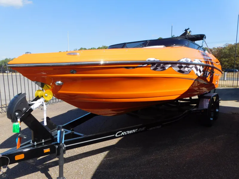 Slide: The Image of 2024 Crownline 240 SS LPX boat in vibrant orange on a trailer. - 3