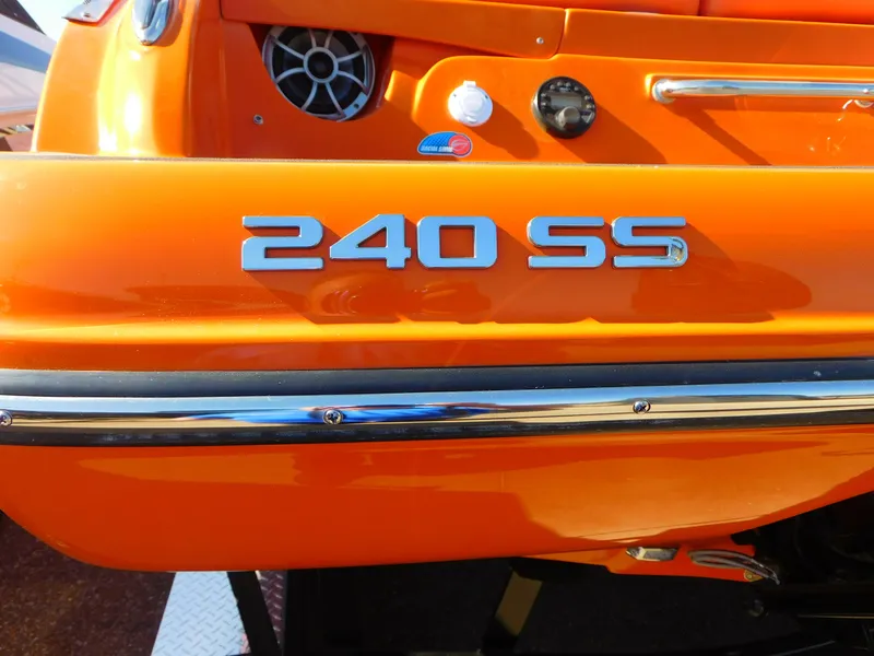 Slide: The Image of 2024 Crownline 240 SS LPX boat, orange exterior, close-up view. - 4