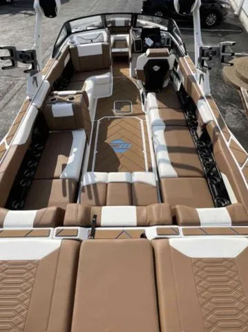 Slide: The Image of 2023 Malibu 26 LSV boat interior with tan and white seating. - 7