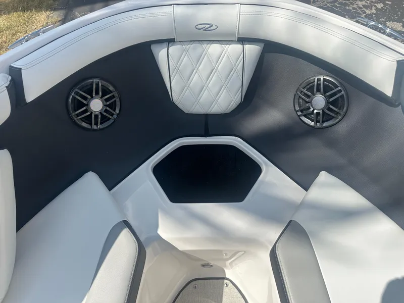 Slide: The Image of 2023 Regal 21 OBX boat interior with speakers and cushioned seating. - 10
