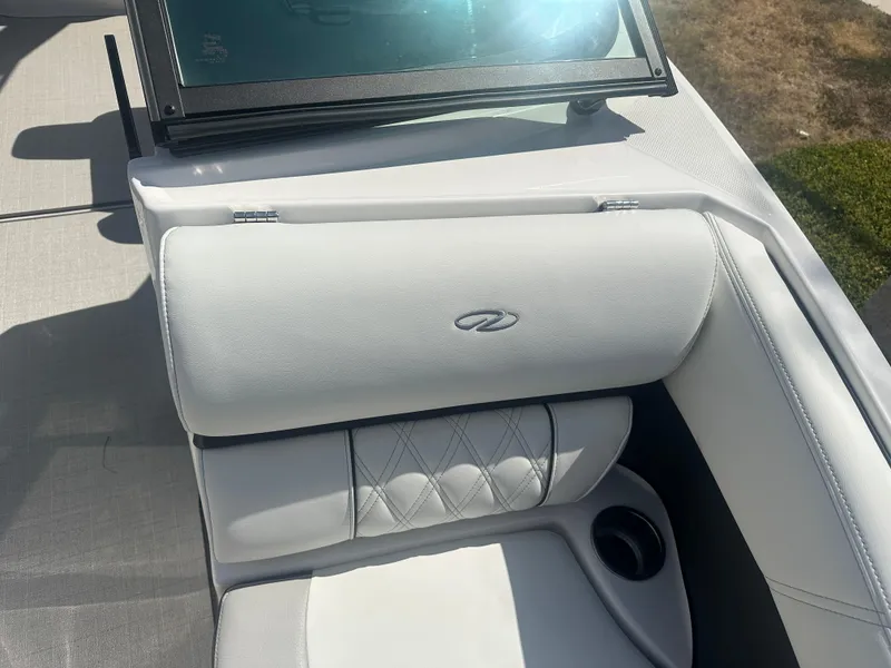 Slide: The Image of 2023 Regal 21 OBX boat interior with white cushioned seating and cup holder. - 11
