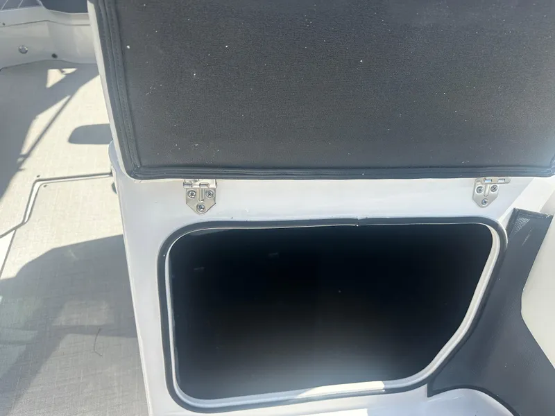Slide: The Image of Open storage compartment on a 2023 Regal 21 OBX boat. - 12