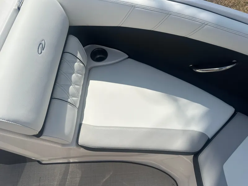 Slide: The Image of 2023 Regal 21 OBX boat interior with white cushioned seating and cup holder. - 13