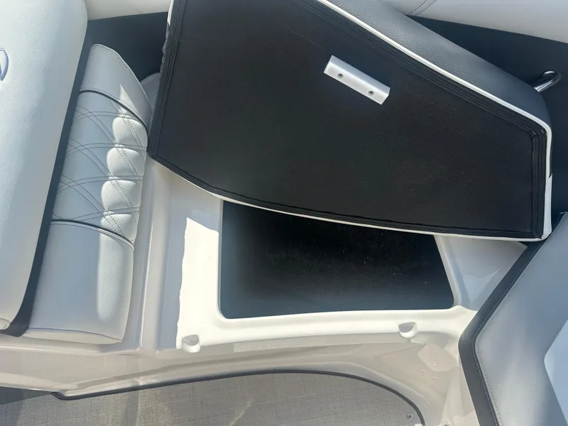 Slide: The Image of 2023 Regal 21 OBX boat storage compartment with open lid, showcasing interior space. - 14